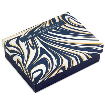 Assorted blush and navy blank note cards with gold foil accents in a reusable marbled storage box.
