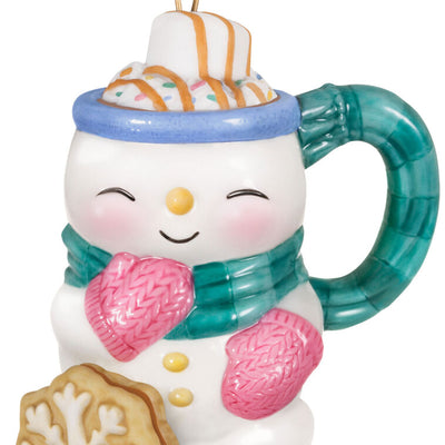 Porcelain ornament shaped like a snowman mug with scarf, pink mittens, marshmallow, caramel drizzle, and snowflake cookie, Hallmark Cup of Cozy series