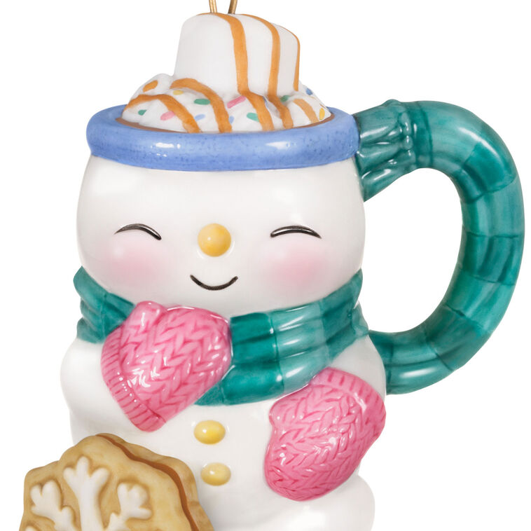 Porcelain ornament shaped like a snowman mug with scarf, pink mittens, marshmallow, caramel drizzle, and snowflake cookie, Hallmark Cup of Cozy series