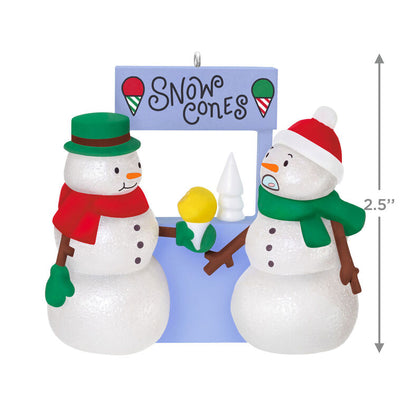 Humorous snowman Christmas ornament offering yellow snow cone to surprised snowperson