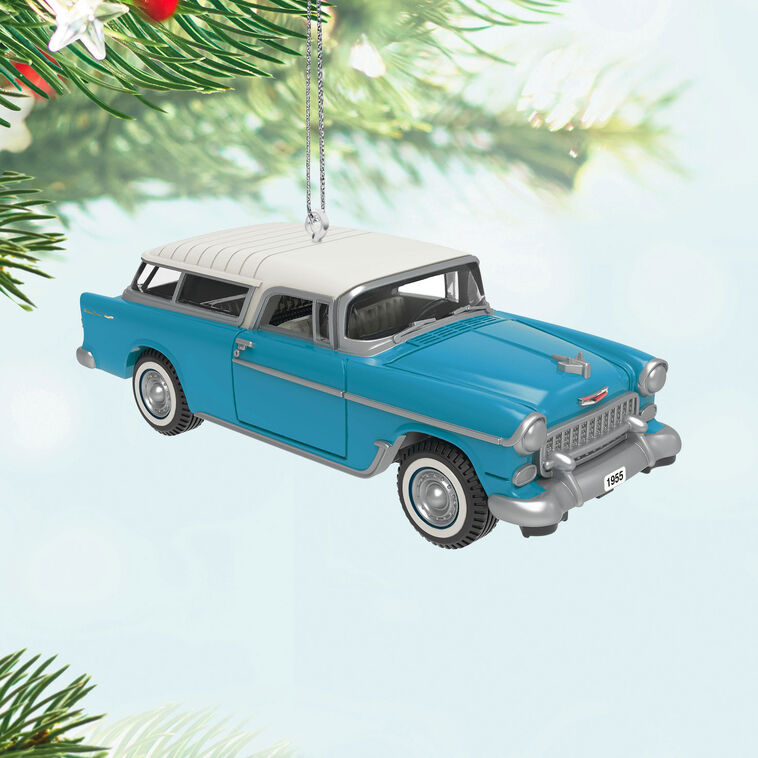 Miniature 1955 Chevrolet Nomad Wagon Christmas ornament in blue and white, featuring vintage styling, turning wheels, and silver accents.