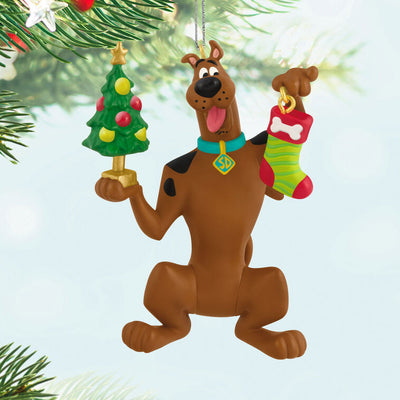 Hallmark Keepsake Tom and Jerry ornament featuring Tom the cat holding Jerry the mouse as a sandwich, with a red napkin tied around his neck.