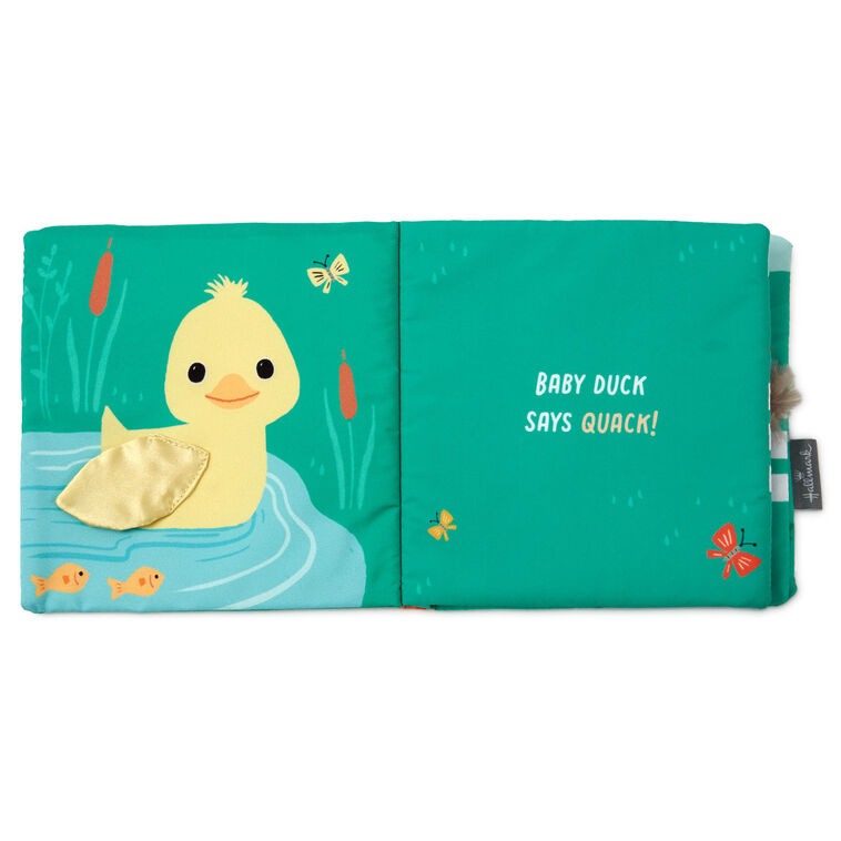 Farm-themed touch-and-feel baby book with soft fabric pages featuring baby duck, pig, horse, and cow illustrations.