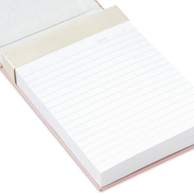 Pastel pink faux leather list pad with gold foil honeycomb design and lined, perforated pages.
