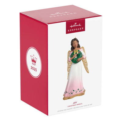 Hallmark Keepsake ornament of angel in pink and white gown with holly vines, holding a green wreath, gold metal wings, glitter accents