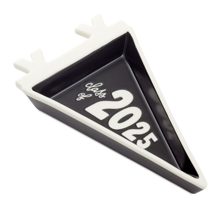 Class of 2025 black-and-white trinket tray with matching socks featuring smiley faces in graduation caps.

