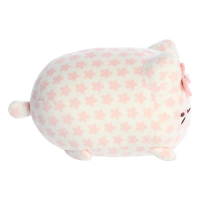 A Sakura Meowchi plush by Aurora in pink with a cherry blossom on its head