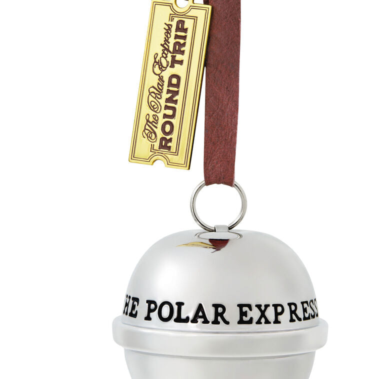 Shiny metal sleigh bell Christmas ornament from The Polar Express with gold ticket tag, faux leather hanger, and commemorative 2025 date.