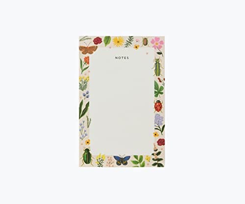 Rifle Paper Co. Bugs and Herbs notepad with a white center, colorful illustrated herb and insect border, and warm white tear-off pages.