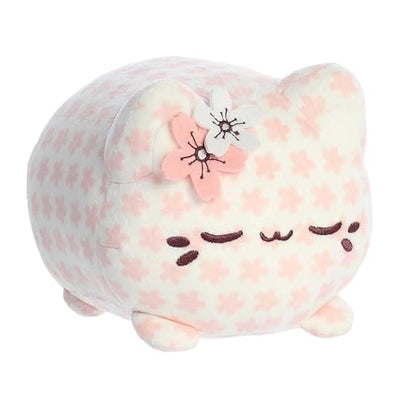 A pink plush cat with a cherry blossom flower on its head.