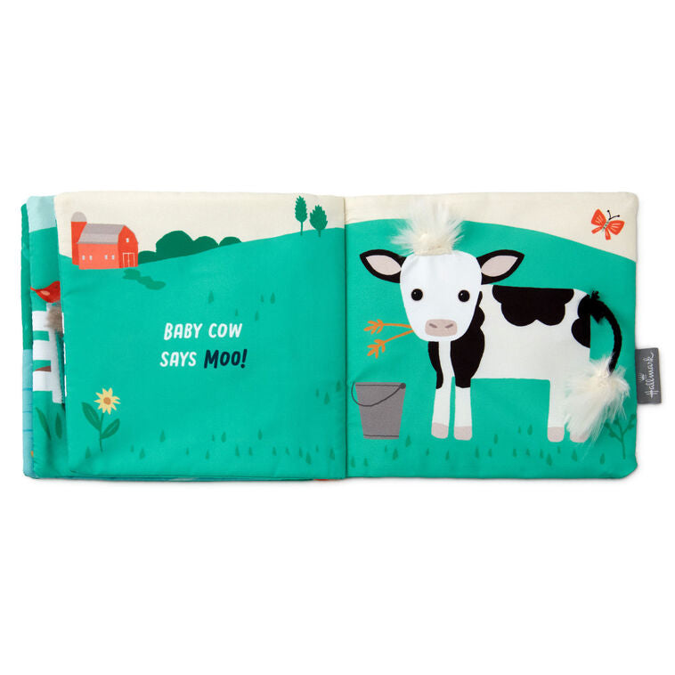 Farm-themed touch-and-feel baby book with soft fabric pages featuring baby duck, pig, horse, and cow illustrations.