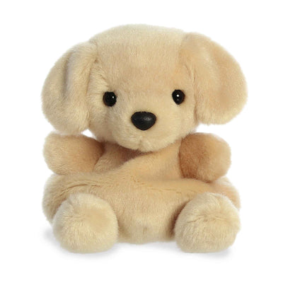 Small brown plush dog sitting on a white surface. 