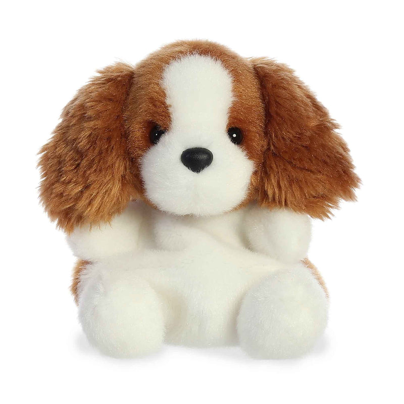 Brown and white plush dog with floppy ears and stitched facial features