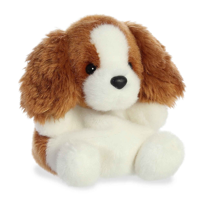 Brown and white plush dog with floppy ears and stitched facial features