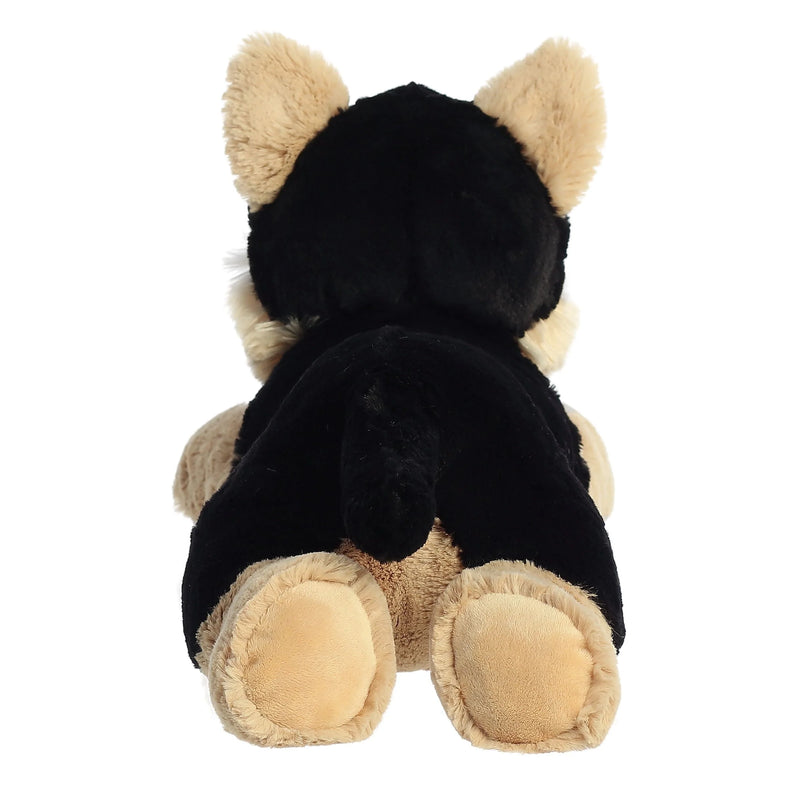 Black and tan plush dog with floppy ears laying down