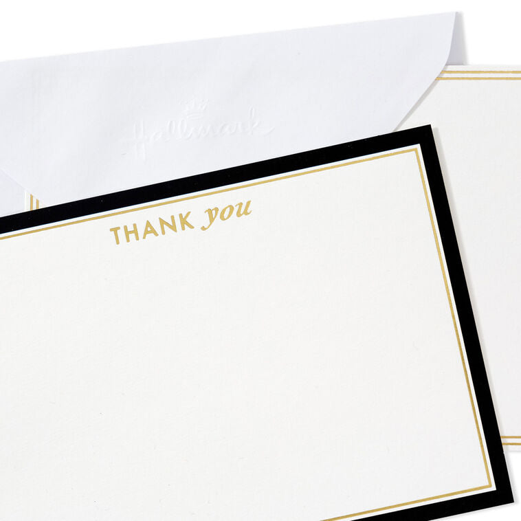 Blank flat note cards with gold lettering and black borders, includes envelopes and white caddy with black geometric lines.