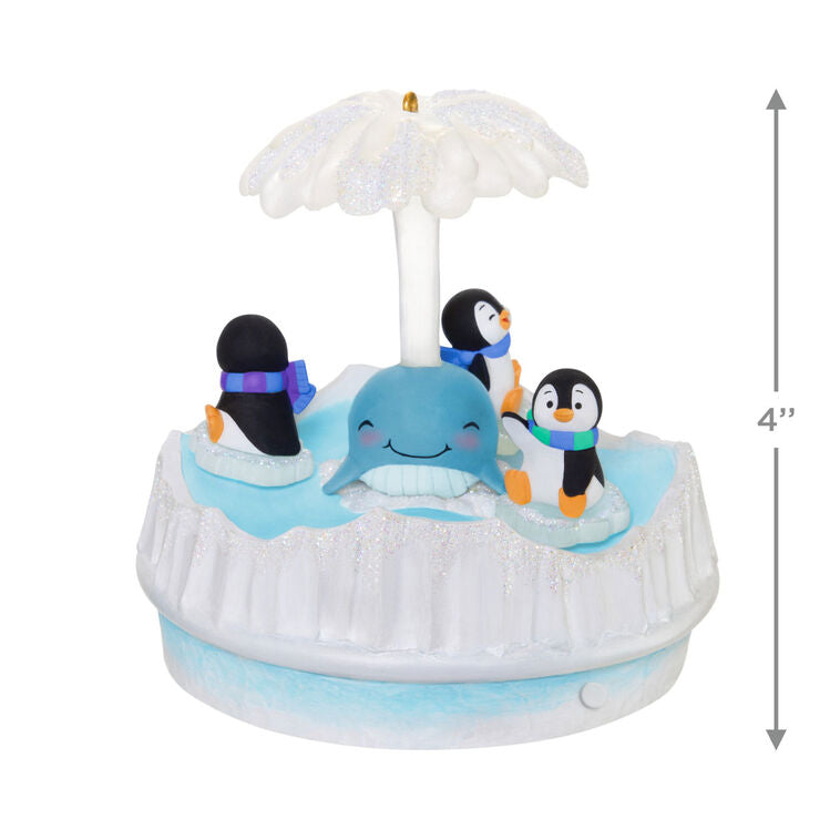 Christmas ornament with three playful penguins spinning on ice pieces around whale, lights and music, battery operated

