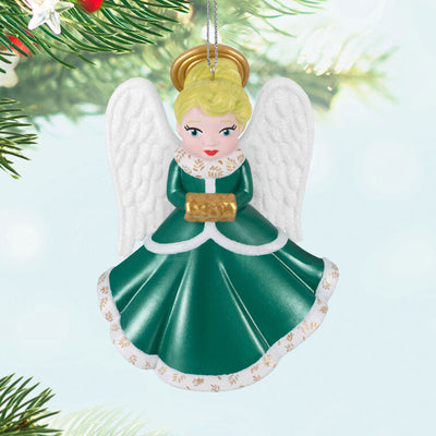Hallmark Keepsake ornament of blonde angel in green and white dress with gold trim, glittery wings, and gold muff