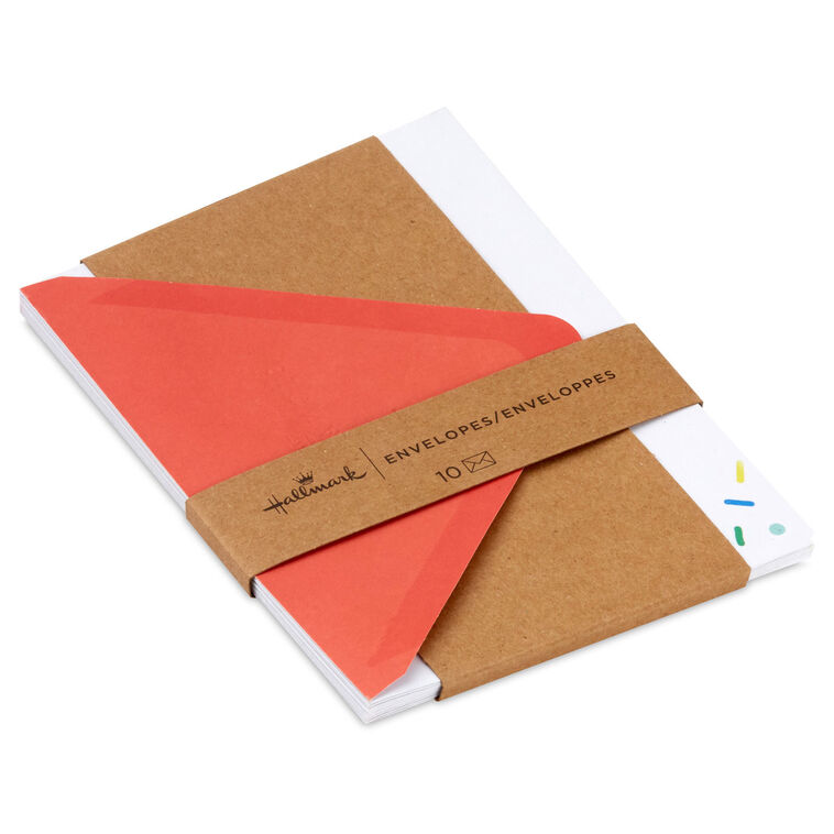 White envelopes with colorful confetti sprinkle design and orange flap interior, perfect for festive notes.
