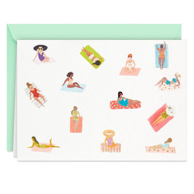 Blank note cards with retro-style illustrations of women sunbathing on colorful beach towels, boxed with envelopes.
