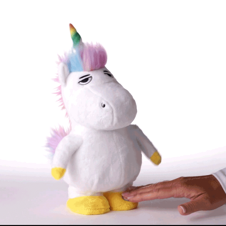 White unicorn plush toy with rainbow mane, tail, and horn, wearing a neutral &