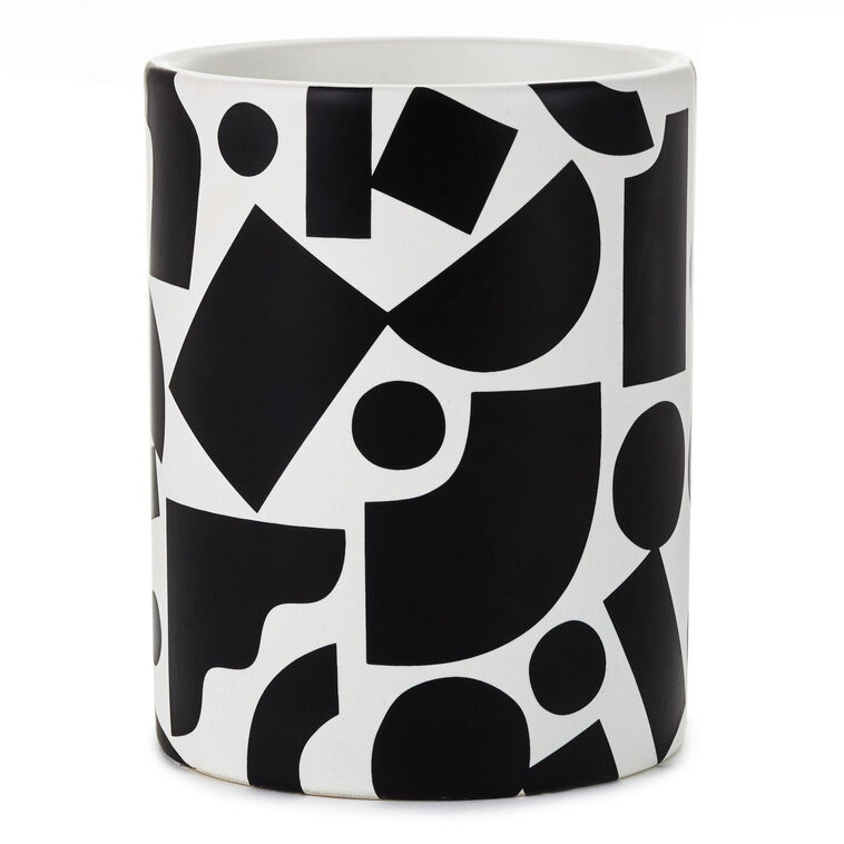 Round ceramic pencil caddy with bold black geometric shapes on a white background.
