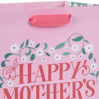 Hallmark medium pink gift bag with floral heart design, green vine, white flowers, and Happy Mother's Day message in red