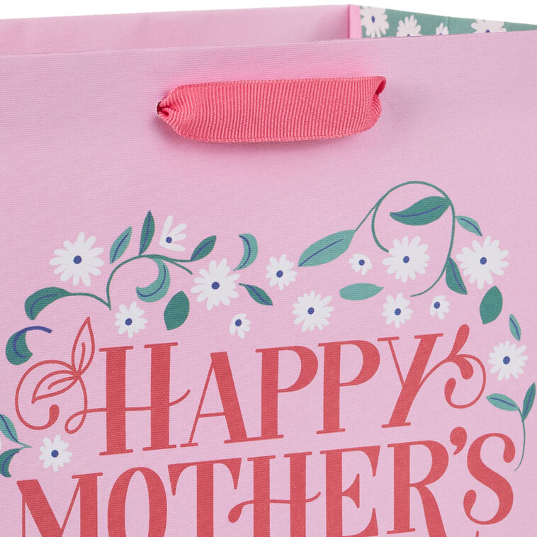 Hallmark medium pink gift bag with floral heart design, green vine, white flowers, and Happy Mother&