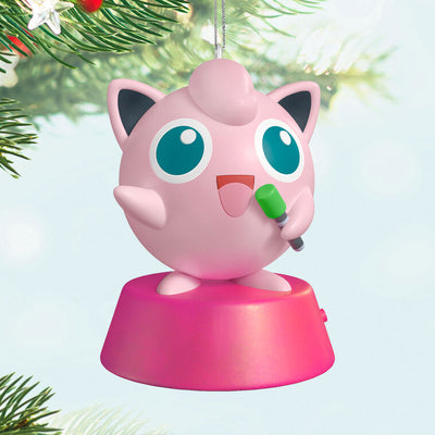 Hallmark Keepsake Pokémon Jigglypuff ornament, pink and round, singing into green microphone, with sound, on pink base.