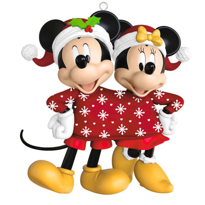 Mickey and Minnie wearing Santa hats and sharing a red Christmas sweater with snowflakes and hearts, Disney ornament.

