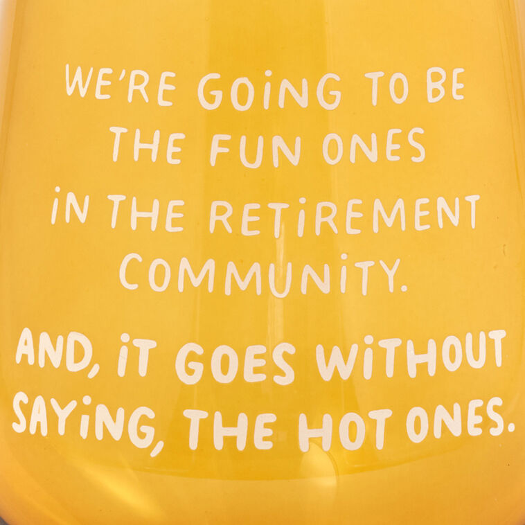 Amber-tinted stemless wine glass with white text: “We&
