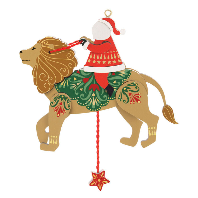 Wooden pull-string ornament of Santa riding a lion with moving reins and legs, inspired by jumping jack toys