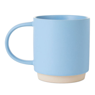 Light blue ceramic mug with “Good things come to those who ask Grandma” text, floral design, and oversized handle.