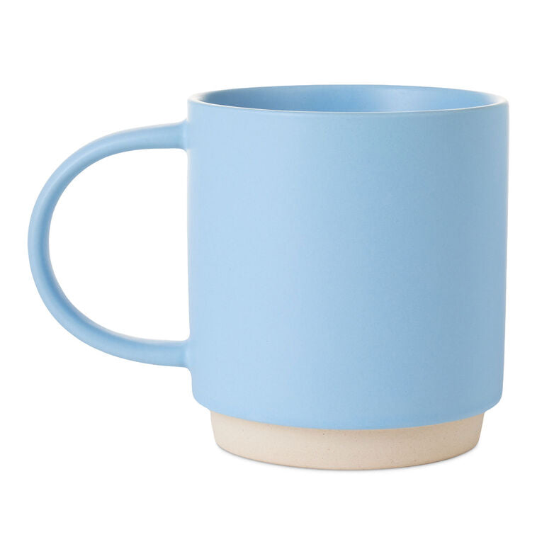 Light blue ceramic mug with “Good things come to those who ask Grandma” text, floral design, and oversized handle.