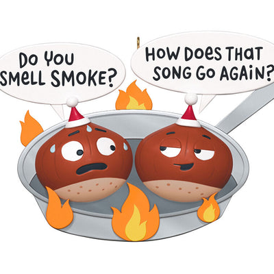 Funny Christmas ornament with two chestnuts roasting in a flaming skillet.

