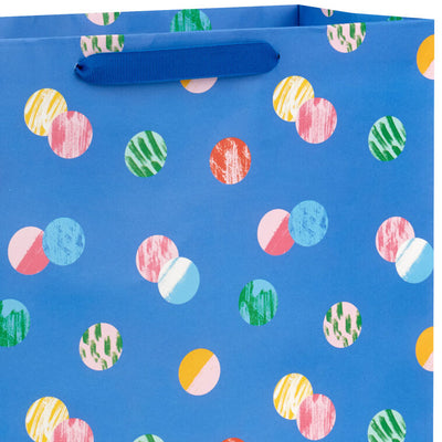 Hallmark extra-large gift bag with playful polka dots on a blue background, ideal for birthdays, holidays, or celebrations.