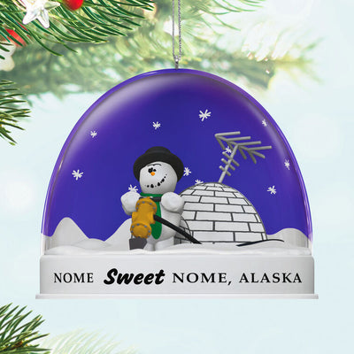 Hallmark Keepsake Knick Knack Snow Globe Escape Plan ornament with snowman inside snow globe labeled Nome, Alaska, Disney/Pixar Christmas decoration.