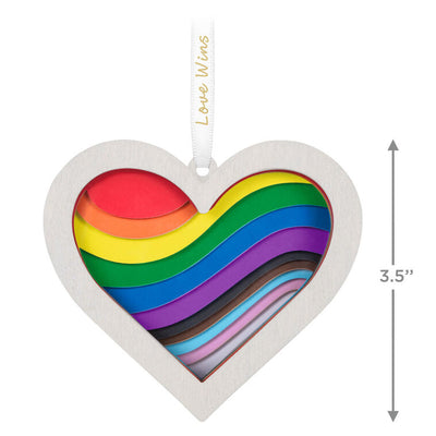 Heart-shaped rainbow papercraft ornament in a whitewashed wood frame with “Love Wins” ribbon for LGBTQIA holiday celebration.