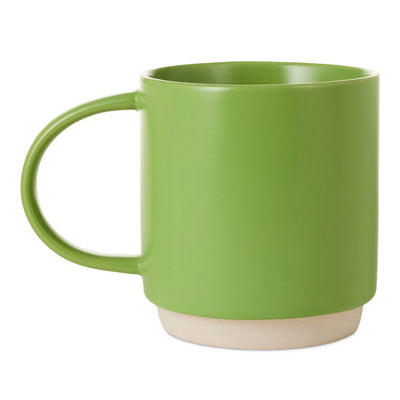Bright green ceramic mug with white lettering that reads “At least one person in this family has their sh!t together