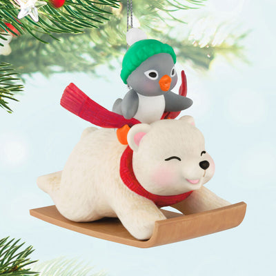 Tuxedo penguin in green hat rides Snowball the polar bear on toboggan, Hallmark Keepsake Christmas ornament