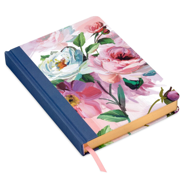 Hardcover journal with purple and pink floral fabric cover, gold-edged pages, and ribbon bookmark.
