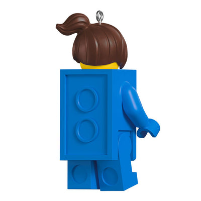 LEGO minifigure ornament with blue brick body, red piece in hand, and smiling brunette girl face.