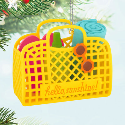 Yellow beach bag ornament with flip-flops, swim towel, sunglasses, and sunscreen, perfect for summer-themed holiday decor

