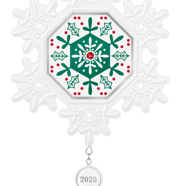 Elegant white porcelain snowflake ornament with red and green accents and red gemstone for 2025