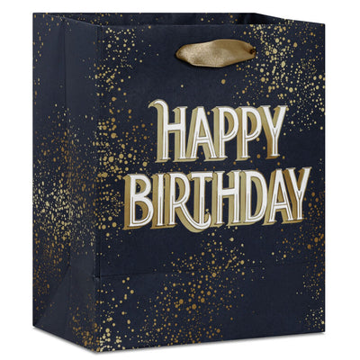 Small Hallmark gift bag with “Happy Birthday” in bold white and gold foil lettering on a navy blue background with gold splatter detail.