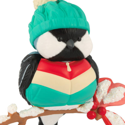 Hallmark Keepsake Cozy Critters ornament—black-capped chickadee in teal stocking hat and striped vest perched on holly branch with glittery snow