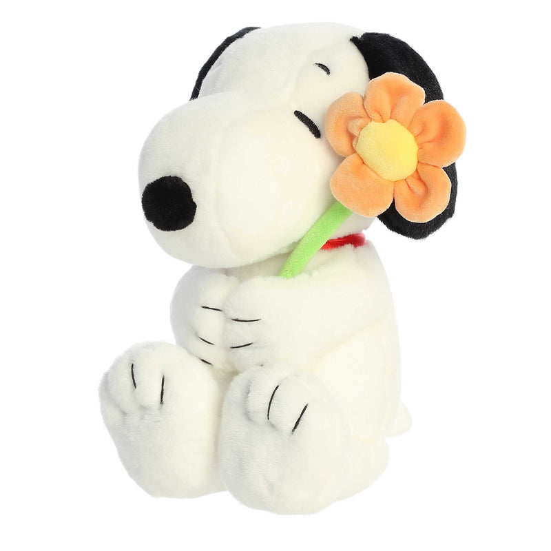 Snoopy plush holding a flower, 11-inch soft black and white stuffed toy from Aurora’s Peanuts collection.