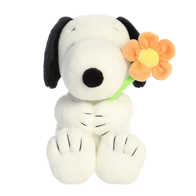 Snoopy plush holding a flower, 11-inch soft black and white stuffed toy from Aurora’s Peanuts collection.