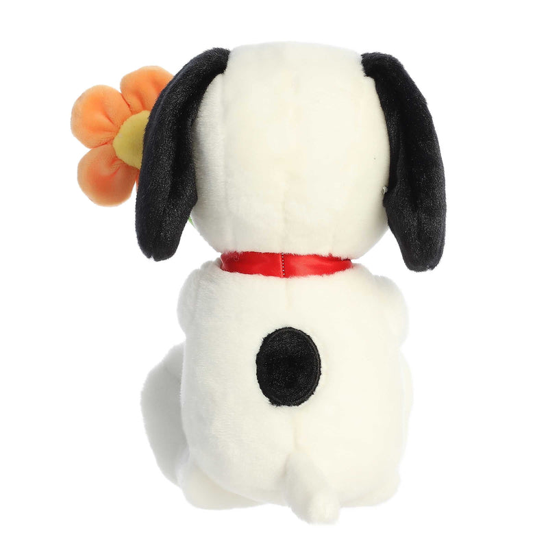 Snoopy plush holding a flower, 11-inch soft black and white stuffed toy from Aurora’s Peanuts collection.
