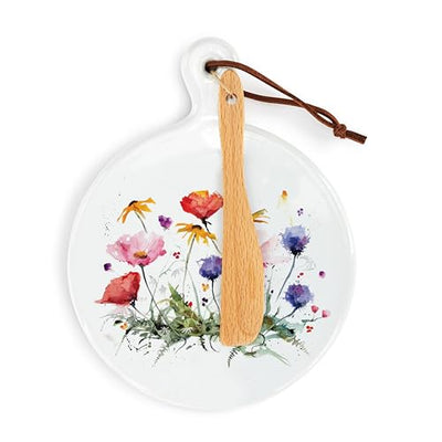 Plate with butter knife and a single pink flower with yellow center.